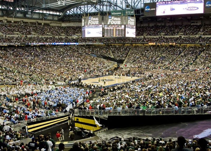 NCAA Final Four basketball game with a crowd of nearly 80,000 fans in the stadium.