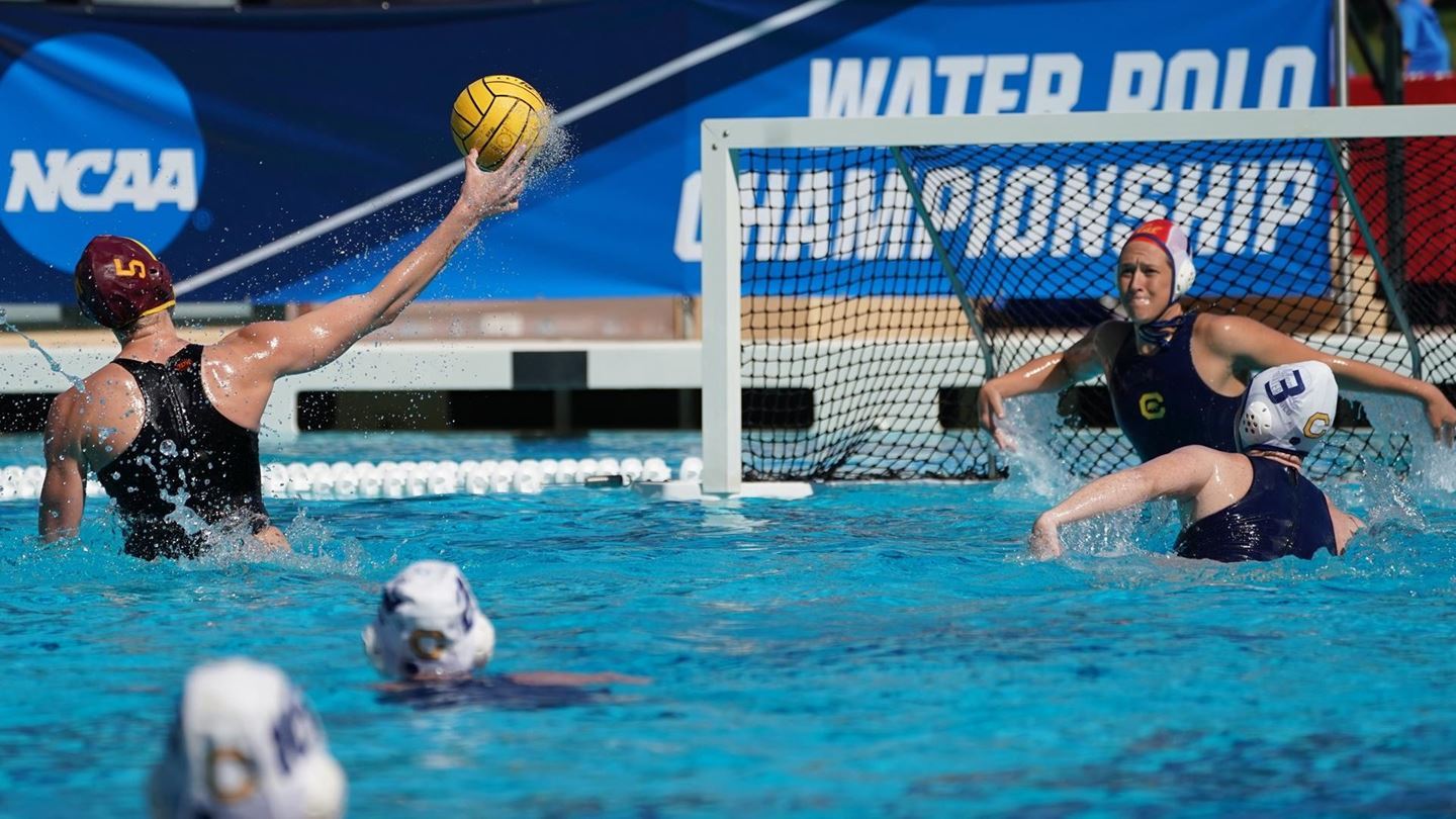 Action in the water: player shoots at the goal during a water polo match.